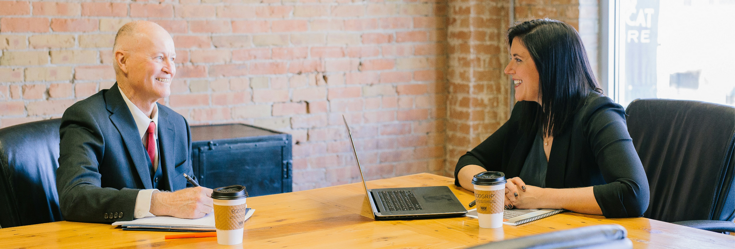 lady and man at table in office